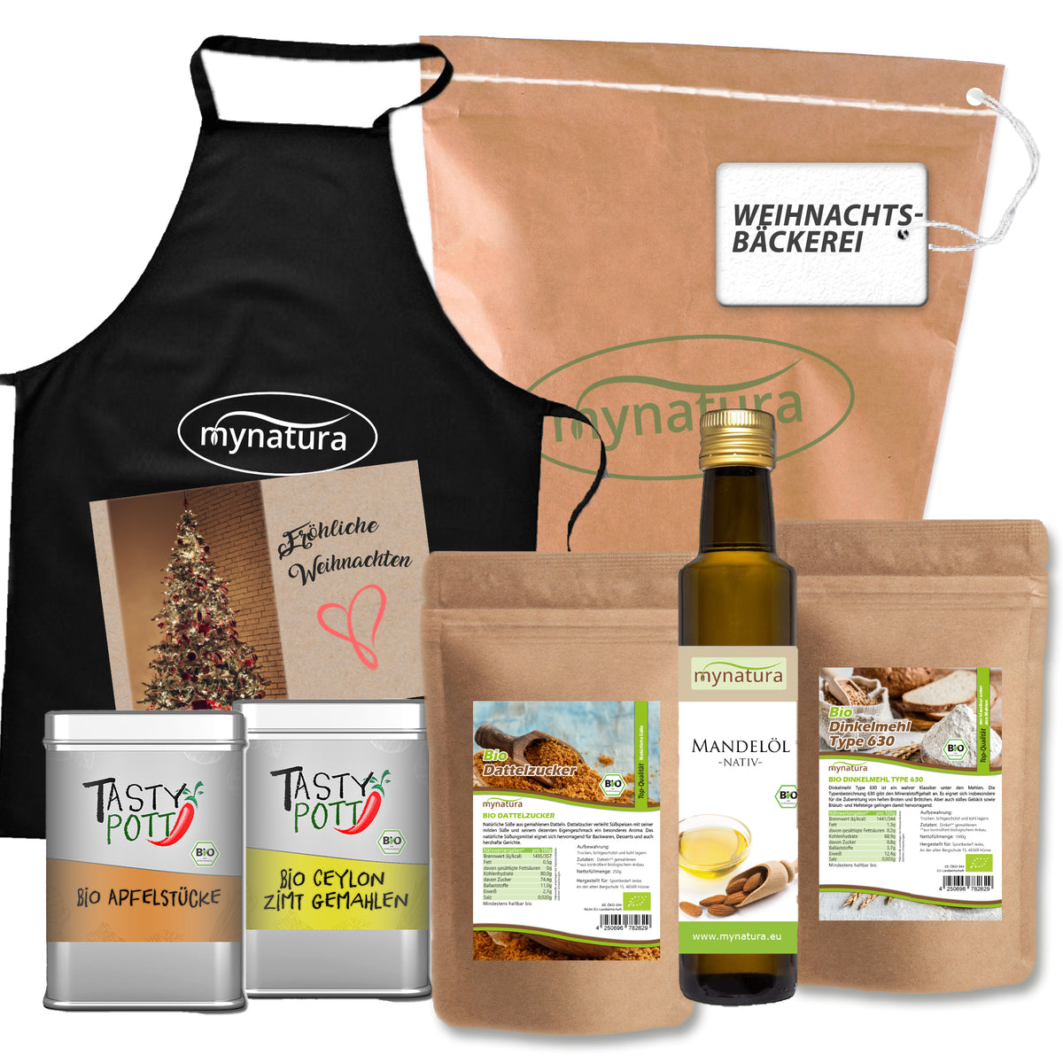 Set aus verschiedenen Bio-Produkten zum Backen und Kochen, darunter Mehle, Mandelöl, Dattelzucker, Apfelstücke, Zimt, eine schwarze Schürze und eine braune Papiertüte mit Weihnachtsmotiv.