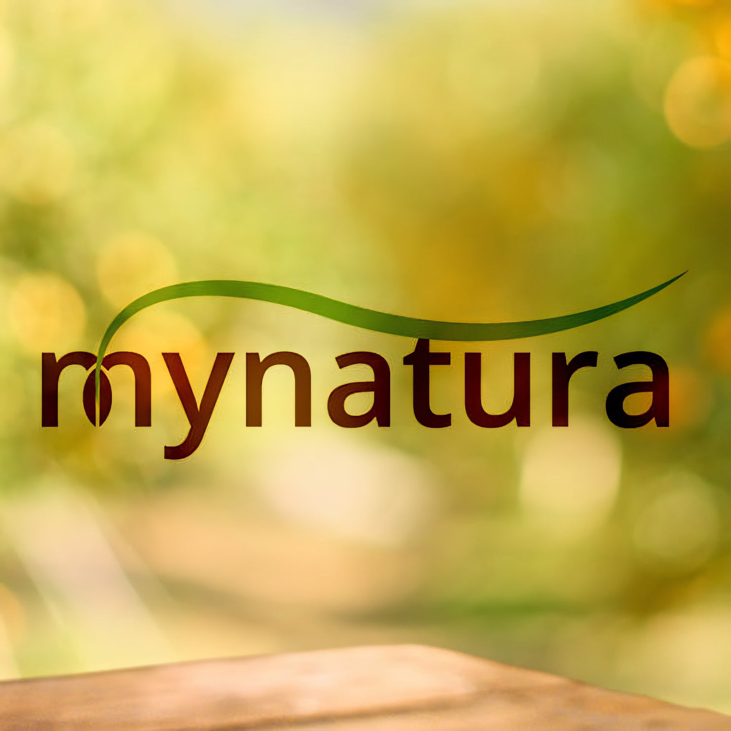 Mynatura Logo vor unscharfem, grün-gelbem Naturhintergrund, Bezug zu Garten und Balkon.