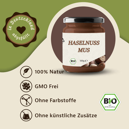 Glas haselnussmus 500g mit Bio-Siegel und Etikett, daneben Symbole für natürliche zutaten, ohne Farbstoffe, ideal als aufstrich oder fürs müsli.