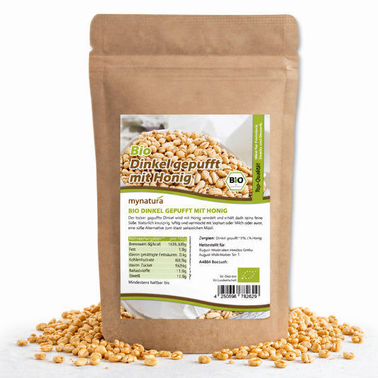 Beutel Bio Dinkel gepufft mit Honig, 400g, aufrecht stehend, mit sichtbarem Etikett und verstreuten gepufften Dinkelkörnern davor.